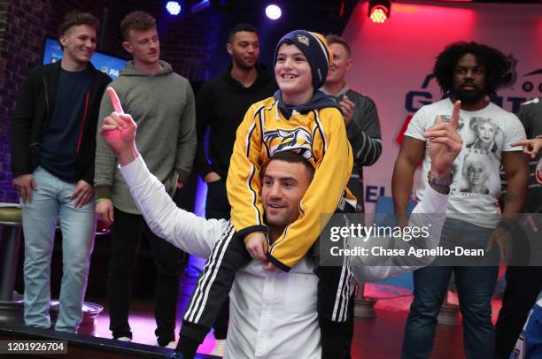 Host Paul "BizNasty" Bissonnette gives a piggy back ride to a fan at the Chel Gaming Challenge as part of the 2020 NHL All-Star weekend on January...