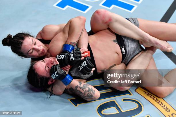 Sara McMann grapples with Lina Lansberg of Sweden in their women's bantamweight bout during the UFC Fight Night event at PNC Arena on January 25,...