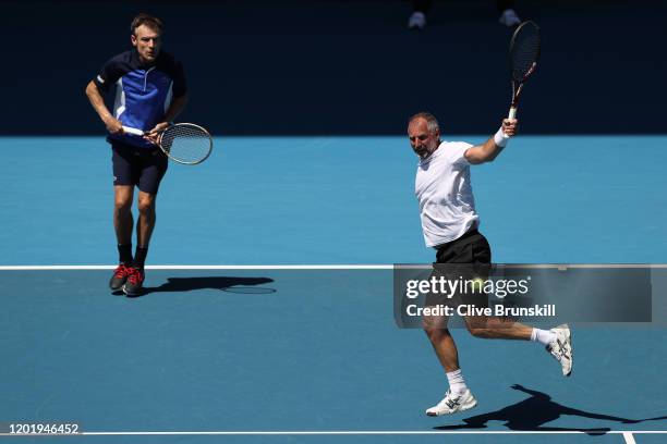 Thomas Muster of Austria and Mats Wilander of Sweden play in their Men's Legends Doubles match against John McEnroe and Patrick McEnroe of the United...