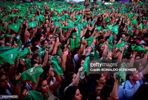 Thousands of women hold green scarves demanding the the decriminalization of abortion as they protest at Argentina's National Congress in Buenos...