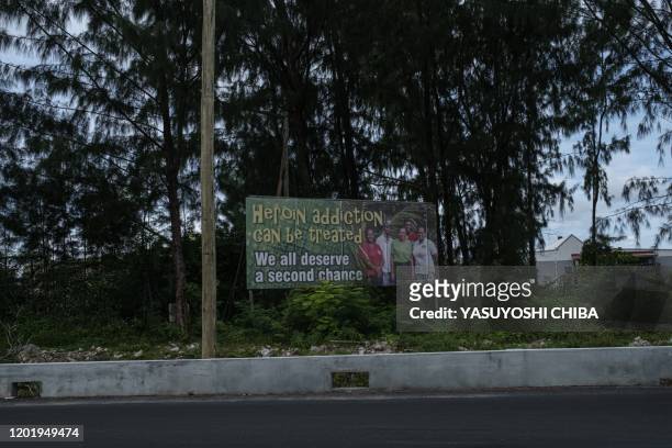 Picture taken on November 20 shows a signboard that reads "Heroin addiction can be treated" in Mahe island, the largest island contains the capital...