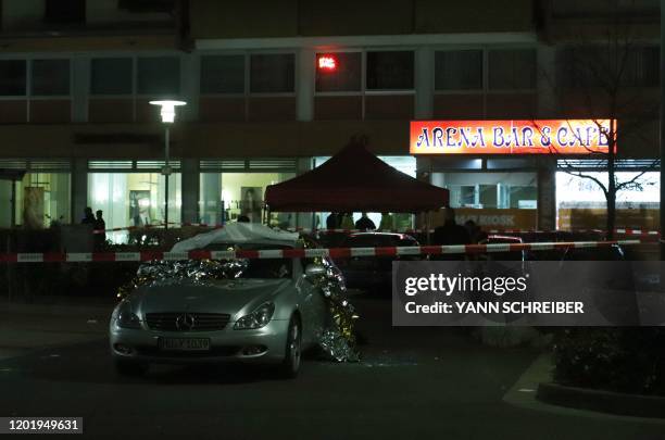 Emergency services work at the scene of a shooting in Hanau, western Germany, on February 20, 2020. - At least eight people were killed in two...