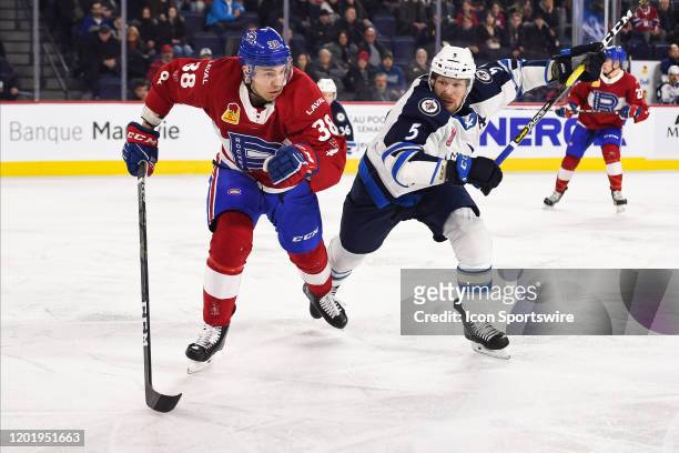 Laval Rocket left wing Yannick Veilleux skates while being chased by Manitoba Moose defenceman Cameron Schilling during the Manitoba Moose versus the...