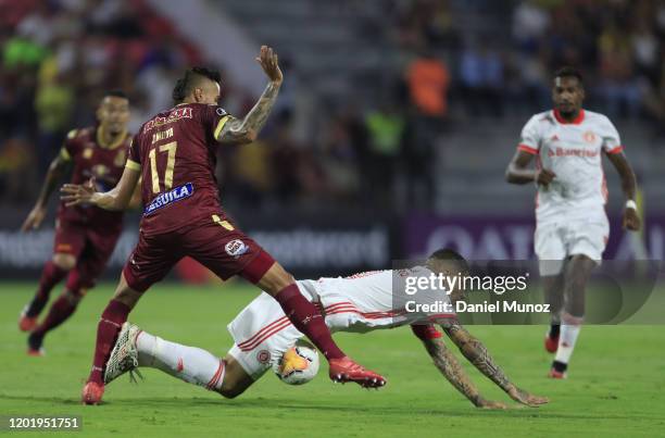 Paolo Guerrero of Internacional is fouled by Jose Moya of Tolima during the third round first leg match between Deportes Tolima and Internacional as...