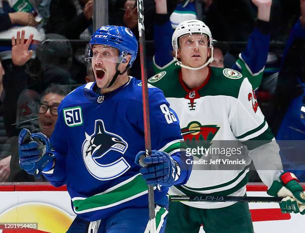 Jonas Brodin of the Minnesota Wild look on dejected as Jay Beagle of the Vancouver Canucks celebrates after scoring during their NHL game at Rogers...