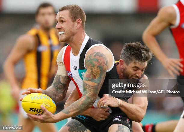 Tim Membrey of the Saints is tackled by Ricky Henderson of the Hawks during the 2020 Marsh Community Series match between the St Kilda Saints and the...