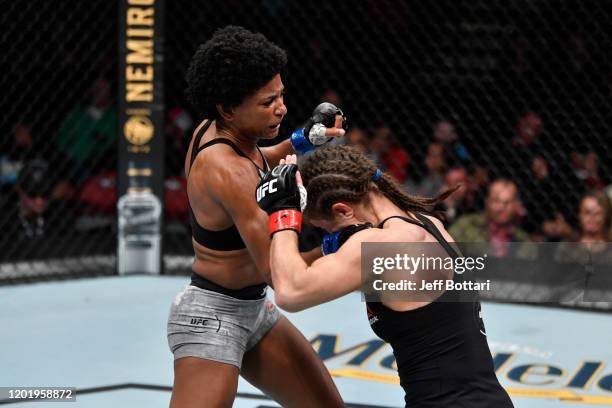 Angela Hill punches Hannah Cifers in their women's strawweight bout during the UFC Fight Night event at PNC Arena on January 25, 2020 in Raleigh,...