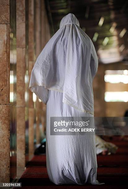 An Indonesian woman prays on the first day of Ramadan at the Istiqlal mosque in Jakarta on August 1, 2011. It is the Islamic month of fasting, in...