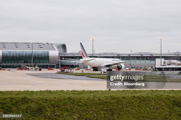 An Air France-KLM Group passenger aircraft stands beside terminal buildings at Charles de Gaulle Airport, operated by Aeroports de Paris, in Roissy,...