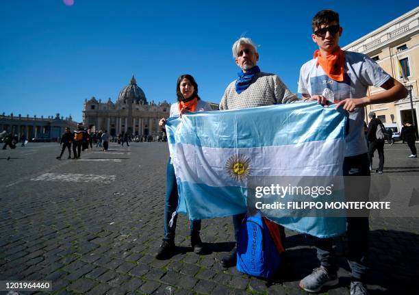 Deaf survivors of clerical sexual abuse Claudia Labeguerie , Daniel Oscar Sgardelis, and Ezequiel Villalonga hold Argentina's flag as they stage a...