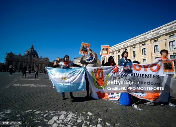Deaf survivors of clerical sexual abuse Claudia Labeguerie , Daniel Oscar Sgardelis, and Ezequiel Villalonga stage a demonstration holding a banner...