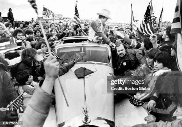 Mike Eruzione, captain of the championship US Olympic hockey team, shakes hands with fans on Feb. 25, 2020 in his hometown of Winthrop, MA in a Rolls...