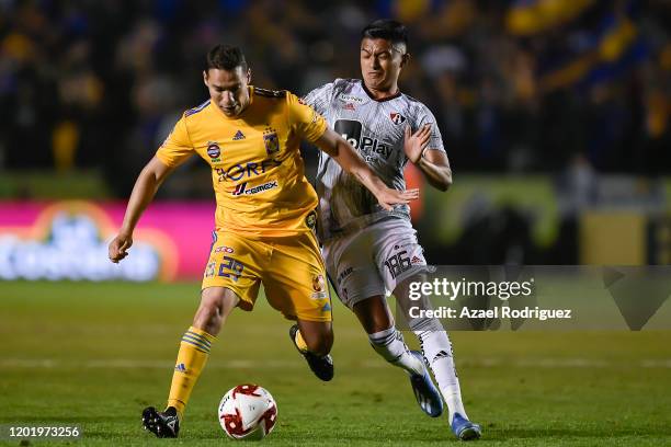 Jesús Dueñas of Tigres fights for the ball with Christopher Trejo of Atlas during the 3rd round match between Tigres UANL and Atlas as part of the...