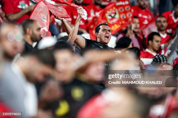Ahly football fans cheer for their team ahead of the Egyptian Super Cup final football match between Ahly SC and Zamalek SC at Mohammed Bin Zayed...
