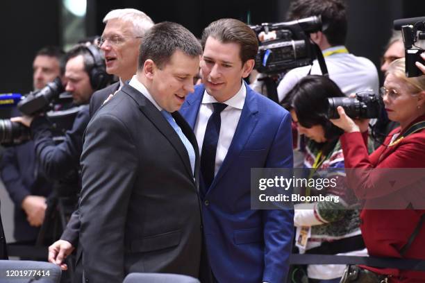 Sebastian Kurz, Austria's chancellor, center, talks with Juri Ratas, Estonia's prime minister, as they arrive for roundtable talks at a European...