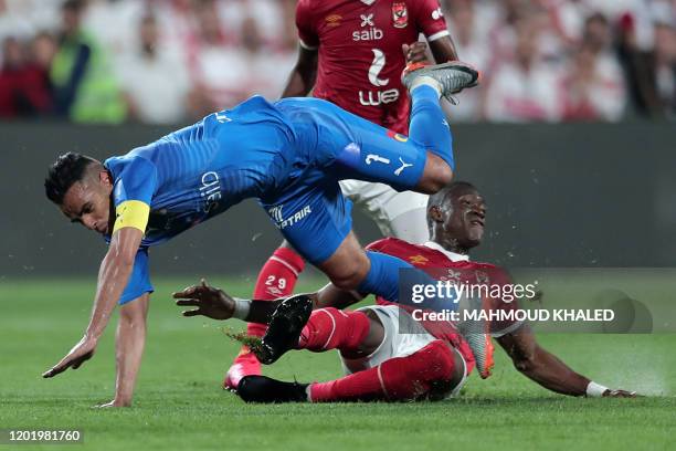 Ahly's midfielder Aliou Dieng tackles Zamalek's defender Hazem Emam during the Egyptian Super Cup final football match between Ahly SC and Zamalek SC...