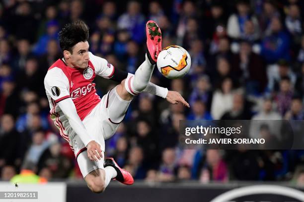 Ajax's Argentine defender Nicolas Tagliafico kicks the ball during the Europa League round of 32 football match between Getafe CF and Ajax Amsterdam...