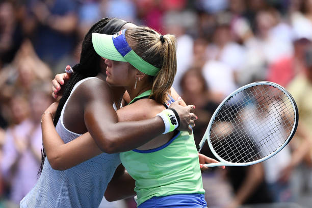 Coco Gauff of the United States hugs Sofia Kenin of the United States at the net following their Women's Singles fourth round match on day seven of...