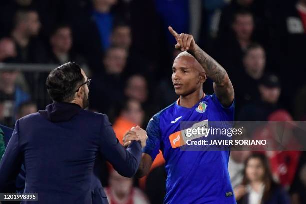 Getafe´s Brazilian forward Deyverson celebrates with Getafe's Spanish coach Jose Bordalas after scoring during the Europa League round of 32 football...