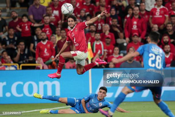 Ahly's defender Mohamed Hani leaps to head the ball while vying against Zamalek's forward Achraf Bencharki during the Egyptian Super Cup final...