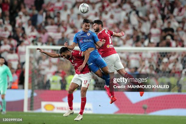 Ahly's midfielder Amr el-Solia and defender Yasser Ibrahim vie for a header against Zamalek's forward Mostafa Mohamed during the Egyptian Super Cup...