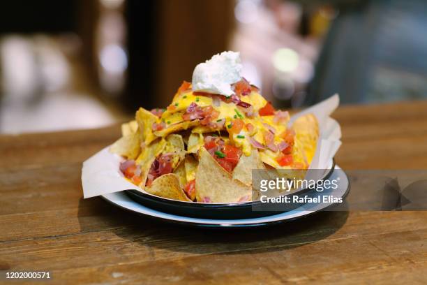 nachos with cheese and ham - mexican food on table stock pictures, royalty-free photos & images