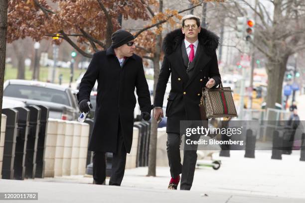 Milo Yiannopoulos, a former editor at Breitbart News, right, arrives for the sentencing of Roger Stone, former adviser to Donald Trump's presidential...