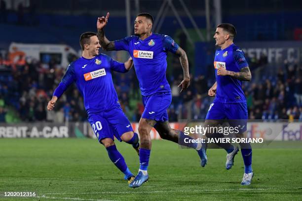 Getafe's Portuguese midfielder Kenedy celebrates after scoring during the Europa League round of 32 football match between Getafe CF and Ajax...