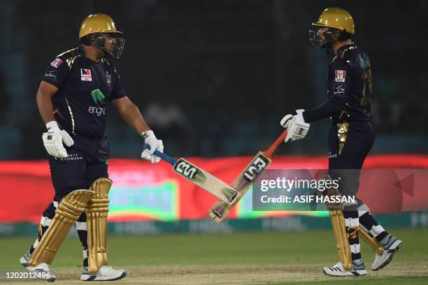 Quetta Gladiators' Azam Khan touches his bat with team mate Mohammad Nawaz during the Pakistan Super League Twenty20 cricket match between Quetta...