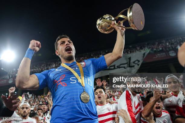 Zamalek's midfielder Tarek Hamed celebrates with the Egyptian Super Cup trophy after his team won the final match against Ahly SC at Mohammed Bin...
