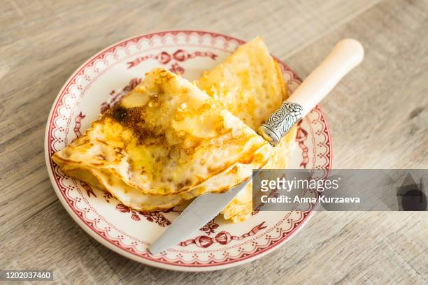 fried pancakes with honey on a plate, selective focus. pancake day or shrove tuesday food. - shrovetide stock pictures, royalty-free photos & images