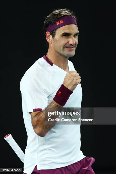 Roger Federer of Switzerland celebrates match point in his Men's Singles fourth round match against Marton Fucsovics of Hungary on day seven of the...