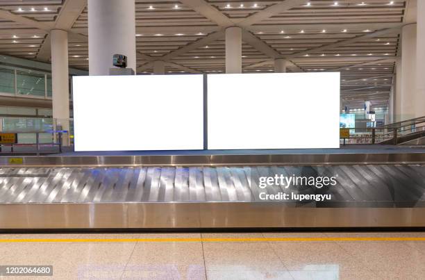 billboard at baggage claim - premiere of winterstone pictures deserted arrivals stockfoto's en -beelden