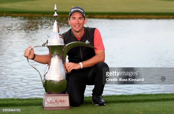 Lucas Herbert of Australia celebrates with the winners trophy after the final round of the Omega Dubai Desert Classic at Emirates Golf Club on...
