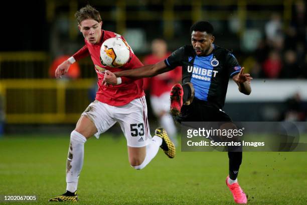 Emmanuel Dennis of Club Brugge, scores the first goal to make it 1-0, Brandon Williams of Manchester United during the UEFA Europa League match...