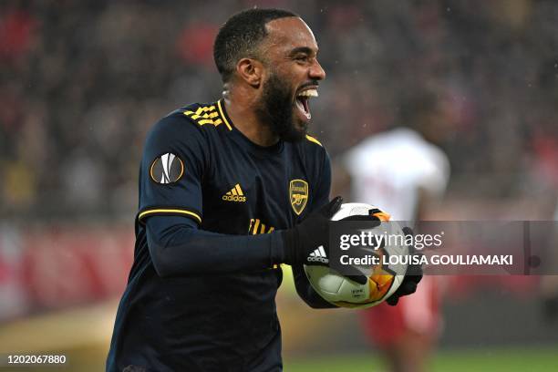 Arsenal's French striker Alexandre Lacazette celebrates after he scores the opening goal of the UEFA Europa League round of 32 first leg football...