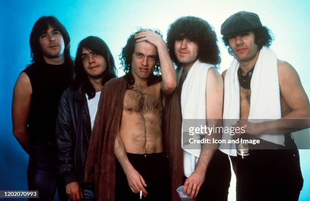 Bassist Cliff Williams, rhythm guitarist Malcolm Young, lead guitarist Angus Young, drummer Simon Wright, and singer Brian Johnson of AC/DC pose...