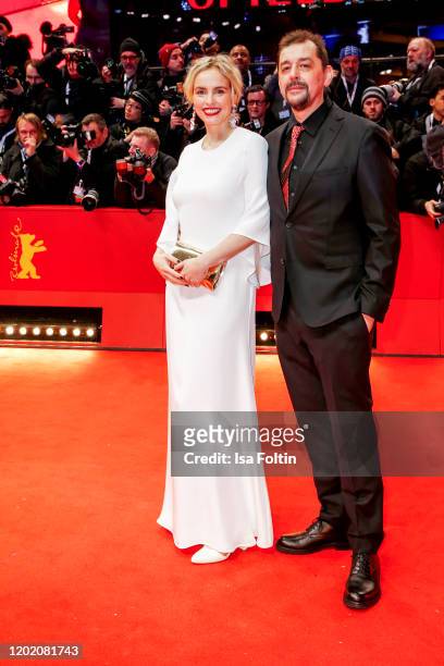 German actress Nina Hoss and her partner Alex Silva arrive for the opening ceremony and "My Salinger Year" premiere during the 70th Berlinale...