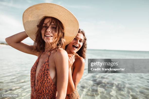 happiness friends at the seaside with panama hat - fashion swimwear stock pictures, royalty-free photos & images