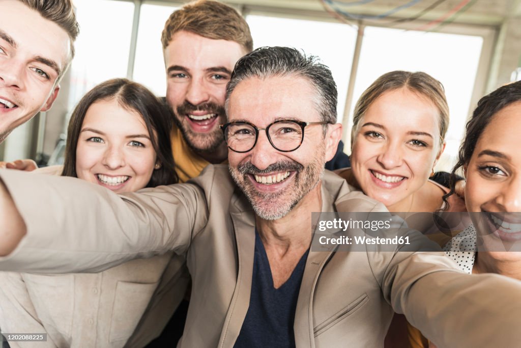 Group portrait of happy business people in office