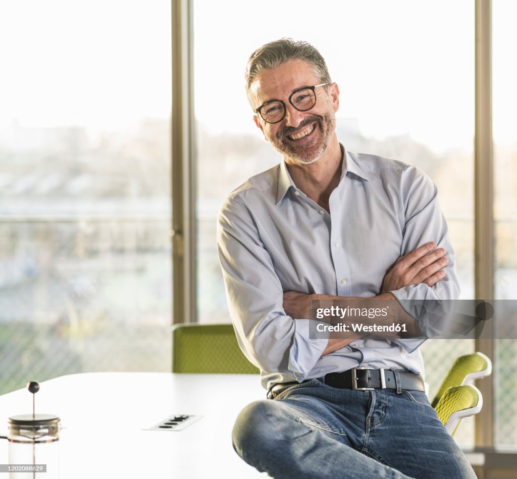 Portrait of a happy mature businessman in office