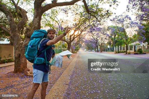 hitchhiker with map on a street, pretoria, south africa - pretoria stock pictures, royalty-free photos & images