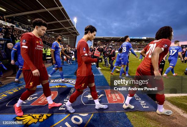 Curtis Jones of Liverpool and Yasser Larouci of Liverpool with Takumi Minamino of Liverpool during lead the team out the FA Cup Fourth Round match...