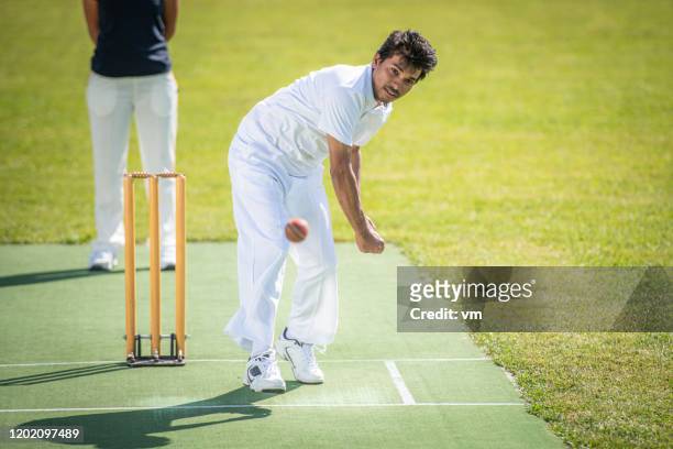 cricket bowler throwing the ball - cricket bowler imagens e fotografias de stock