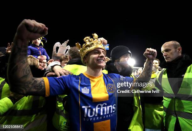 Jason Cummings of Shrewsbury Town celebrates victory wearing a blow-up crown during the FA Cup Fourth Round match between Shrewsbury Town and...