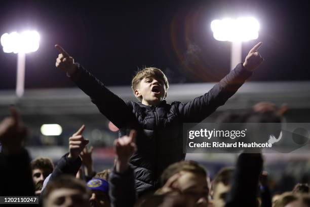 Shrewsbury fans celebrate on the pitch at the final whistle during the FA Cup Fourth Round match between Shrewsbury Town and Liverpool at New Meadow...