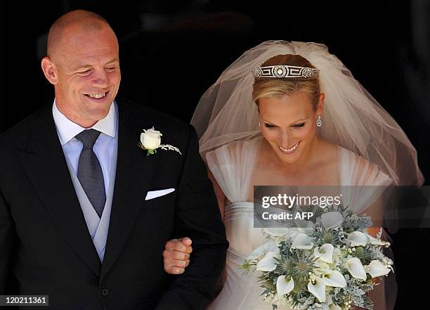 England rugby player Mike Tindall and his new bride Britain's Zara Phillips, granddaughter of Queen Elizabeth II, leave after their wedding ceremony...