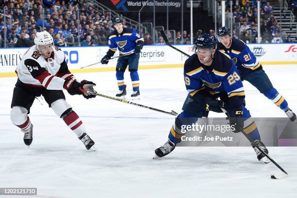 Carl Soderberg of the Arizona Coyotes pressures Ivan Barbashev of the St. Louis Blues at Enterprise Center on February 20, 2020 in St. Louis,...