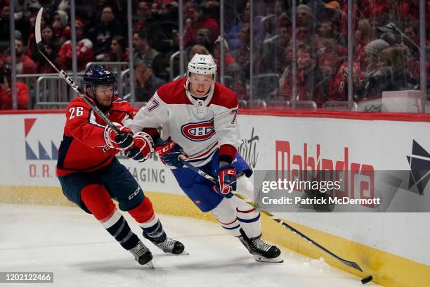 Brett Kulak of the Montreal Canadiens skates with the puck against Nic Dowd of the Washington Capitals in the third period at Capital One Arena on...