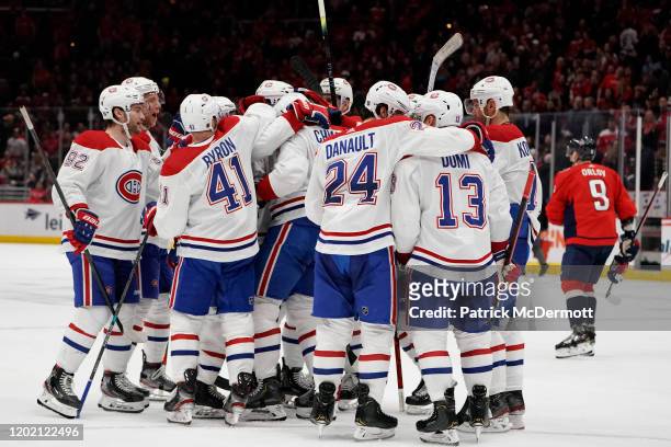Ben Chiarot of the Montreal Canadiens celebrates with his teammates after scoring the game winning goal against the Washington Capitals in overtime...